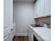 Well-lit laundry area with white cabinets and modern washer and dryer units at 405 Newstyle Way, Gastonia, NC 28056