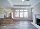 Bright living room featuring hardwood floors, large windows, and a fireplace at 405 Newstyle Way, Gastonia, NC 28056