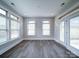 Sunlit room with hardwood floors, multiple windows, and white trim at 405 Newstyle Way, Gastonia, NC 28056