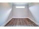 Neutral room with hardwood floors, white trim, and a single horizontal window at 405 Newstyle Way, Gastonia, NC 28056