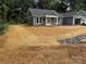 Charming single-story home with a blue exterior, white trim, and a freshly mulched front yard at 415 Dogwood Ln, Statesville, NC 28625