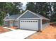 Beautiful home featuring a two-car garage, gray siding, and landscaped front yard at 415 Dogwood Ln, Statesville, NC 28625
