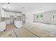 View of the open concept kitchen with white cabinets and a kitchen island at 415 Dogwood Ln, Statesville, NC 28625