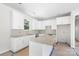 A modern kitchen featuring white cabinetry, granite countertops, and an island at 415 Dogwood Ln, Statesville, NC 28625