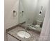 Elegant powder room featuring a granite countertop vanity and a large mirror at 415 Dogwood Ln, Statesville, NC 28625