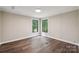 Bright bedroom featuring stylish wood-look flooring and two sunny windows at 5001 Grand Canyon Nw Rd, Concord, NC 28027