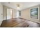 Bright bedroom with wood-look flooring and two windows bringing in natural light at 5001 Grand Canyon Nw Rd, Concord, NC 28027