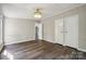 Bedroom with wood-look flooring, two closets, and an adjacent room visible through a doorway at 5001 Grand Canyon Nw Rd, Concord, NC 28027