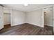 Bedroom featuring wood-look flooring, closet and a view to the ensuite bath at 5001 Grand Canyon Nw Rd, Concord, NC 28027