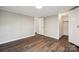 Bedroom with stylish wood-look floors, closet and doorway leading to an adjacent room at 5001 Grand Canyon Nw Rd, Concord, NC 28027