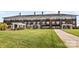 Low-rise brick building with multiple stories, balconies, manicured lawn, and sidewalk at 5001 Grand Canyon Nw Rd, Concord, NC 28027