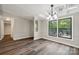 Dining area featuring new flooring, two large picture windows, and access to an outdoor deck at 5001 Grand Canyon Nw Rd, Concord, NC 28027