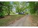 Cozy single-story home with a large front yard and mature trees providing ample shade at 5001 Grand Canyon Nw Rd, Concord, NC 28027