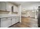 Kitchen featuring updated countertops, cabinets and backsplash with views of an adjacent living area at 5001 Grand Canyon Nw Rd, Concord, NC 28027