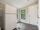 Mud room features a large refrigerator and access to the home's exterior at 5001 Grand Canyon Nw Rd, Concord, NC 28027