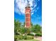 Close up shot of unique brick and granite Bell Tower with lush landscaping on a sunny day at 510 Wiley Ave, Salisbury, NC 28144