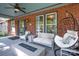 Comfortable front porch featuring a fire pit, egg chair, sofa and loveseat with a ceiling fan at 510 Wiley Ave, Salisbury, NC 28144