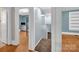 Hallway with hardwood floors leading to carpeted stairs and a bedroom at 510 Wiley Ave, Salisbury, NC 28144