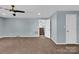 Open-concept living room with carpet, natural light, and a doorway to the stairs at 510 Wiley Ave, Salisbury, NC 28144