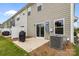 Back of a two-story home featuring a patio and green yard with a grill at 5207 Maynard Hill Dr, Monroe, NC 28110