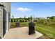 Backyard featuring a concrete patio, grill, air conditioning unit, and a well-maintained lawn with green grass at 5207 Maynard Hill Dr, Monroe, NC 28110