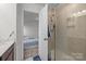 Bright bathroom with a glass enclosed shower and open door to bedroom at 5207 Maynard Hill Dr, Monroe, NC 28110