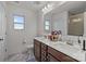 Bright bathroom with a double vanity, quartz countertop, and large framed mirror at 5207 Maynard Hill Dr, Monroe, NC 28110