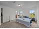 Light bedroom featuring natural light, neutral carpet and access to the en suite at 5207 Maynard Hill Dr, Monroe, NC 28110