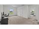 Bright bedroom offering neutral carpet, white walls, natural light, and view to additional room at 5207 Maynard Hill Dr, Monroe, NC 28110