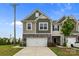 Inviting townhome featuring a stone-accented front, two-car garage, and a well-manicured lawn at 5207 Maynard Hill Dr, Monroe, NC 28110