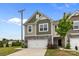 Beautiful townhome featuring a stone-accented facade, two-car garage, and a neatly kept lawn at 5207 Maynard Hill Dr, Monroe, NC 28110
