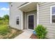 Home's front entrance showcases a modern black door and an ADT security sign at 5207 Maynard Hill Dr, Monroe, NC 28110