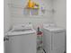 Functional laundry room with washer, dryer, and storage shelf at 5207 Maynard Hill Dr, Monroe, NC 28110