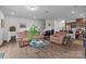 Open-concept living room with view into kitchen and staircase, furnished with cozy seating at 5207 Maynard Hill Dr, Monroe, NC 28110