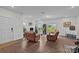 Cozy living room features hardwood floors, two recliner chairs, and a sliding glass door to the backyard at 5207 Maynard Hill Dr, Monroe, NC 28110