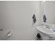 Practical powder room with white pedestal sink, towel hooks and toilet paper holder at 5207 Maynard Hill Dr, Monroe, NC 28110