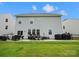 Back exterior view with patio, barbecue and outdoor furniture, and a grassy lawn at 5581 Soft Shell Dr, Lancaster, SC 29720