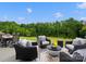 Backyard patio featuring cushioned wicker furniture with a view of a lush green space at 5581 Soft Shell Dr, Lancaster, SC 29720