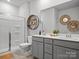 Modern bathroom with double vanity sinks and a glass-enclosed shower at 5581 Soft Shell Dr, Lancaster, SC 29720
