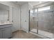 Bathroom featuring a glass-enclosed shower, a tiled shower surround, and a single sink vanity at 5581 Soft Shell Dr, Lancaster, SC 29720