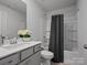 Well-lit bathroom with a combined shower and tub featuring gray tile and modern fixtures at 5581 Soft Shell Dr, Lancaster, SC 29720
