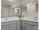 Bathroom featuring a dual vanity with white countertops, gray cabinets, and a large mirror at 5581 Soft Shell Dr, Lancaster, SC 29720