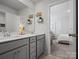 Bathroom with double sink vanity and decor, open to view of bedroom in background at 5581 Soft Shell Dr, Lancaster, SC 29720