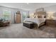 Spacious bedroom with a wooden bed frame, decorative accents, and natural light at 5581 Soft Shell Dr, Lancaster, SC 29720
