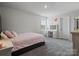 Bright bedroom features a bed, vanity with lighted mirror, and gray carpet at 5581 Soft Shell Dr, Lancaster, SC 29720