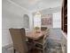 Elegant dining room featuring a rustic wood table, chandelier, and neutral decor at 5581 Soft Shell Dr, Lancaster, SC 29720