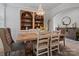 Elegant dining room featuring a rustic wood table, chandelier, and built-in shelves at 5581 Soft Shell Dr, Lancaster, SC 29720