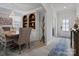Dining area with a chandelier and a view into the entryway with blue-patterned rug at 5581 Soft Shell Dr, Lancaster, SC 29720