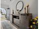 Inviting entryway with wood-look floors and a decorative console table with a round mirror and candles at 5581 Soft Shell Dr, Lancaster, SC 29720