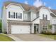 Charming two-story home featuring a stone facade, black shutters, and a manicured lawn at 5581 Soft Shell Dr, Lancaster, SC 29720